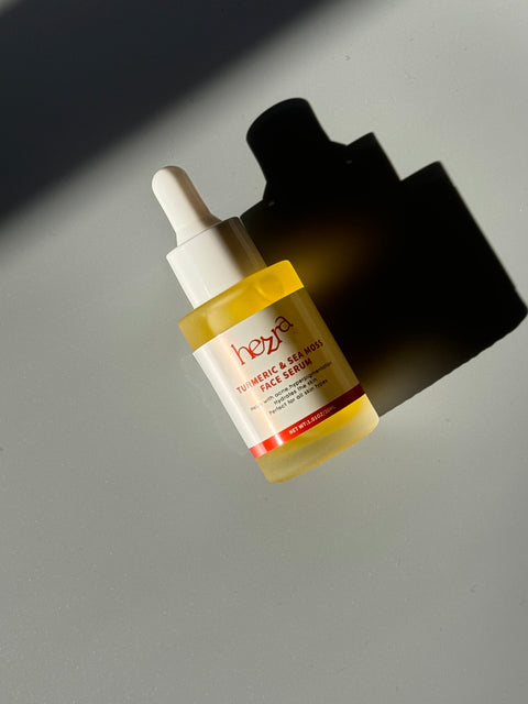 a bottle of face serum made with turmeric sitting on top of a table